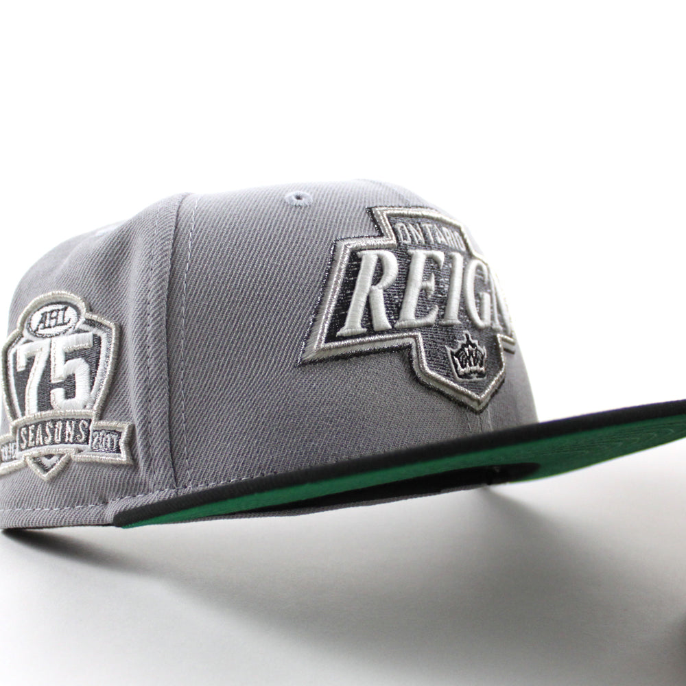 https://www.ecapcity.com/cdn/shop/files/Ontario-Reign-75th-Anniversary-New-Era-59Fifty-Fitted-Hat-_Gray-Black-Green-Under-Brim_-1_1024x1024.jpg?v=1706990743