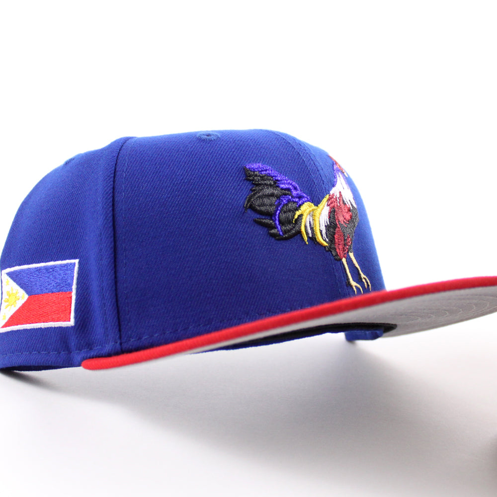 https://www.ecapcity.com/cdn/shop/files/ROOSTER-Philippines-Flag-New-Era-59Fifty-Fitted-Hat-_Royal-Blue-Scarlet-Red-Gray-Under-Brim_-1.jpg?v=1695749147